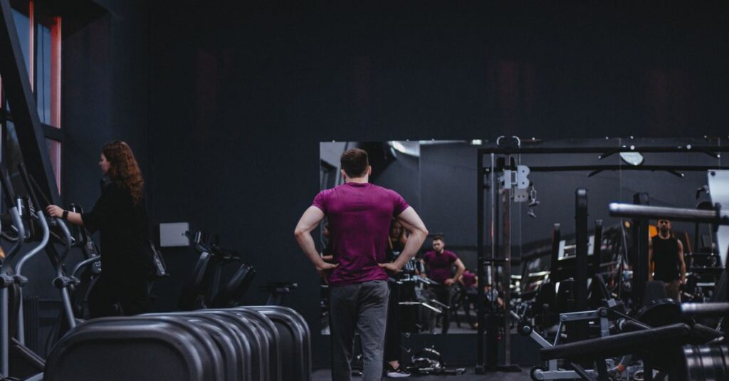 Man in a gym with fitness equipment, highlighting a healthy lifestyle.