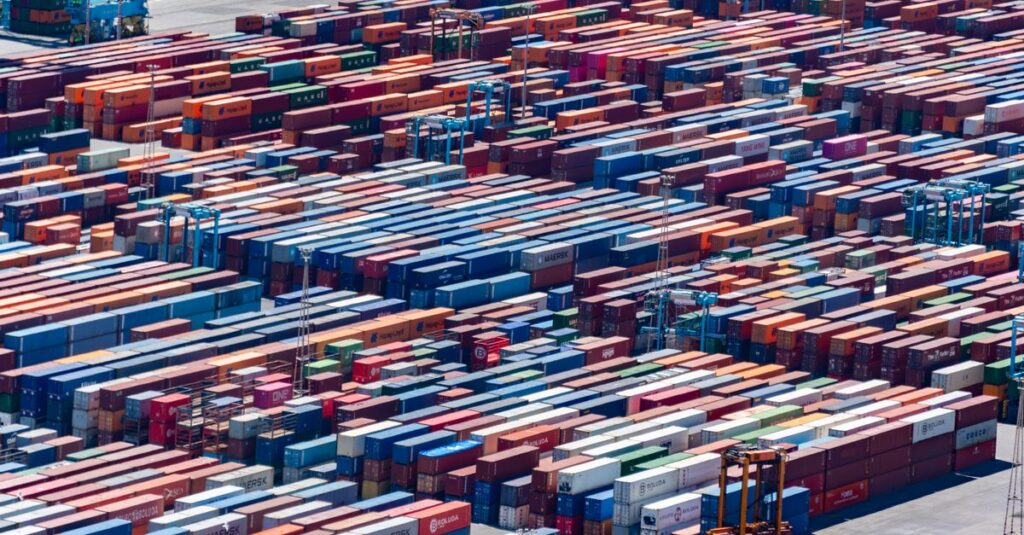 A bustling port with colorful cargo containers, aerial view showcasing global trade.