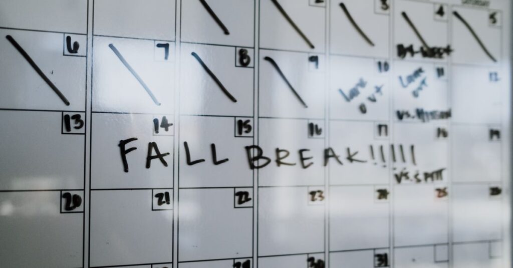 Close-up of a whiteboard calendar with 'FALL BREAK' written in bold letters.