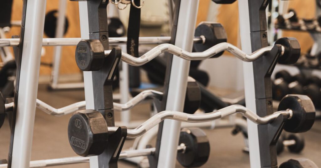 Organized dumbbell rack in a well-equipped modern gym for fitness and strength training.