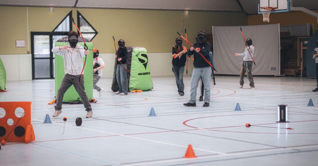 Group playing archery tag indoors with bows, arrows, and masks.