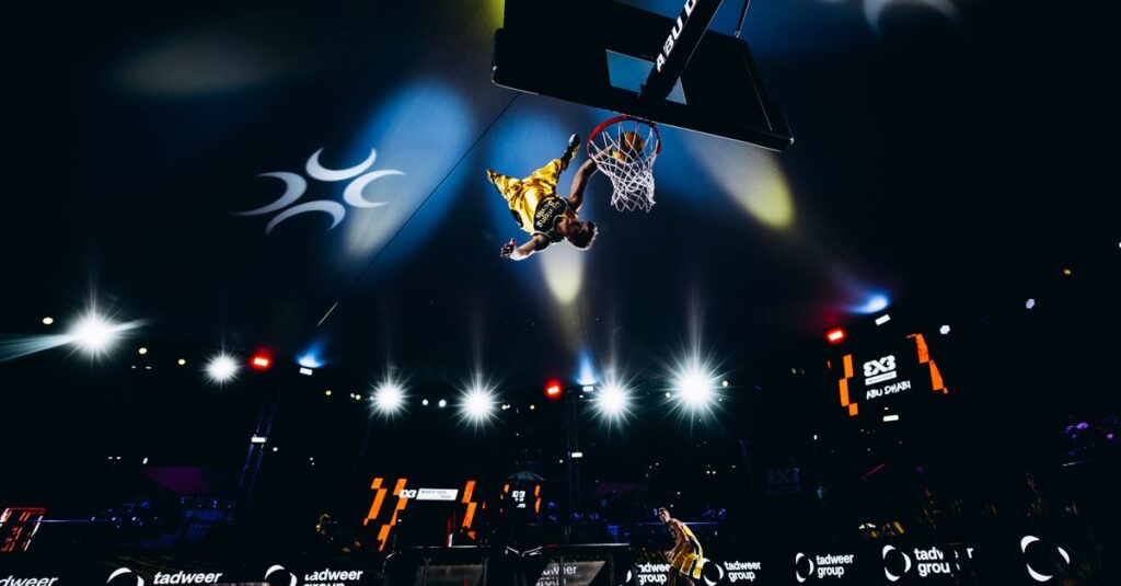 High-energy slam dunk action at a basketball game in Abu Dhabi, UAE.