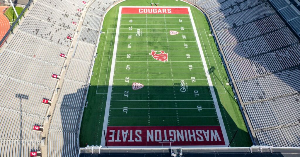 Aerial shot of Washington State University's football stadium, beautifully capturing the green field and empty stands.