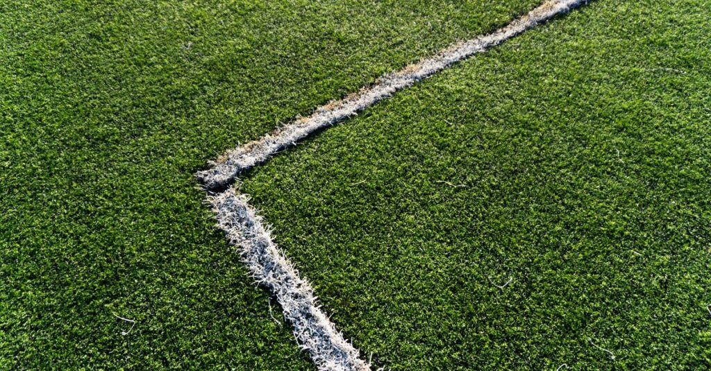 Detailed view of white lines on green soccer field turf, Istanbul, Turkey.