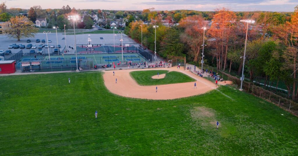 Aerial view capturing a baseball game in a Philadelphia park during sunset.
