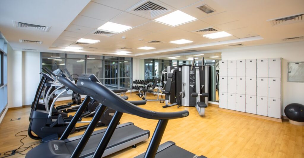 Spacious gym interior featuring treadmills, fitness machines, and lockers.
