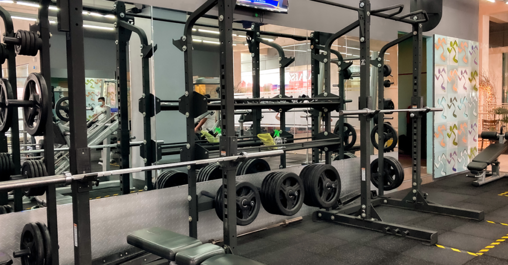 A spacious gym featuring benches, weights, and exercise machines for varied workouts.
