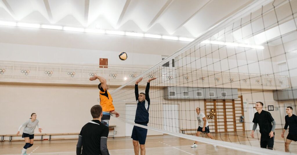 Dynamic scene of a competitive indoor volleyball game with players in action.