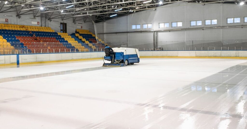 An ice resurfacer smooths the surface of an indoor ice skating rink.