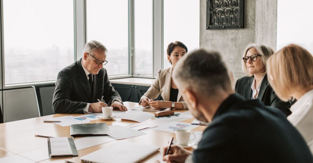 Business professionals engaged in a collaborative meeting around a conference table.