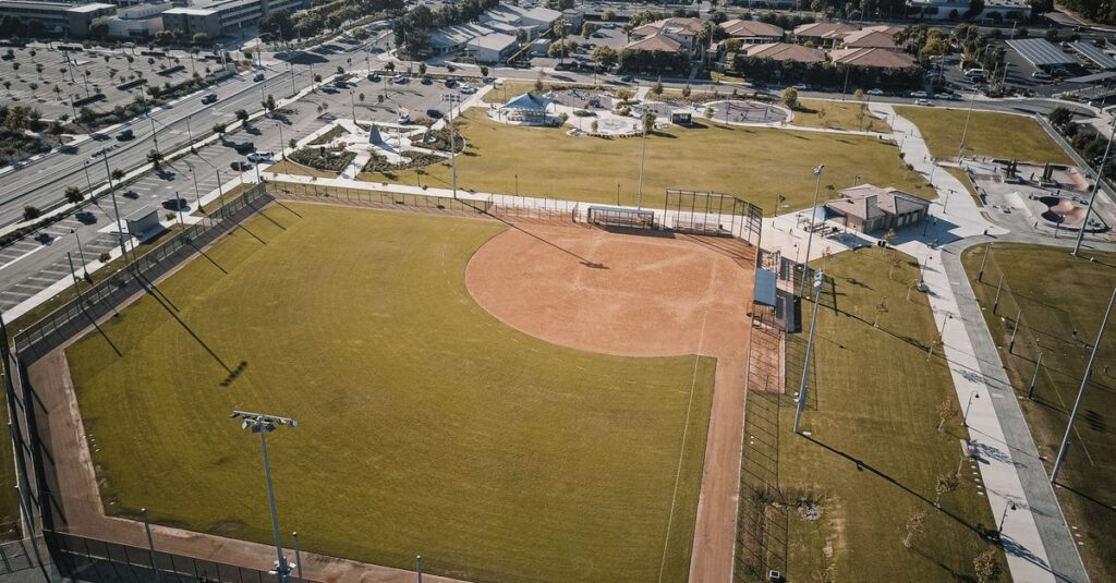 Captivating aerial shot of a baseball field set in an urban sprawling city park.