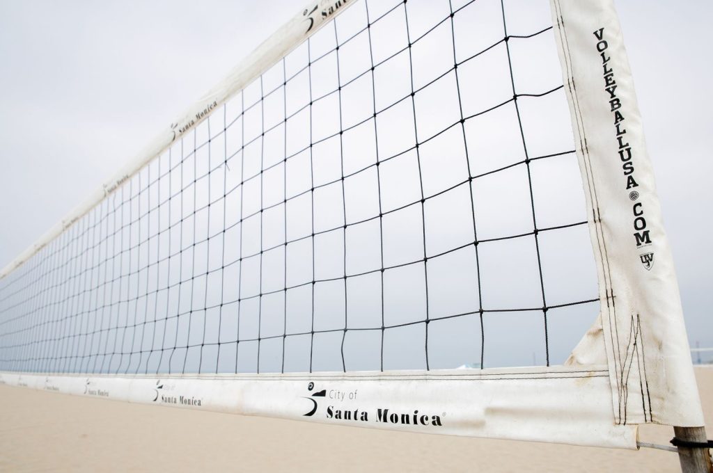 Close-up of a volleyball net on Santa Monica beach, ideal for sports themes.