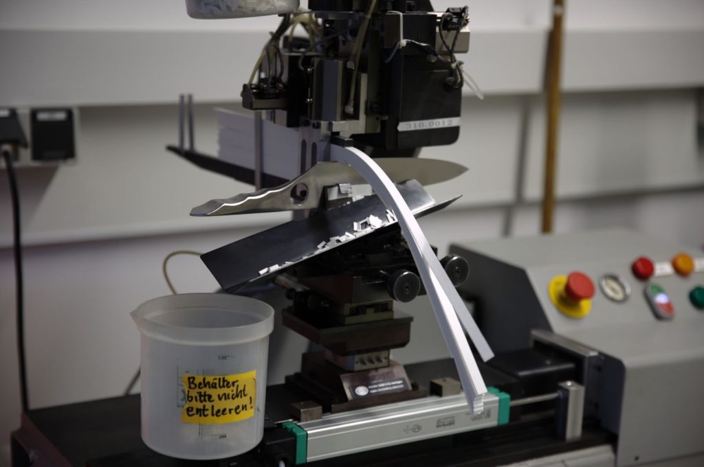 Close-up of knife testing machine in Solingen, showcasing precision engineering.