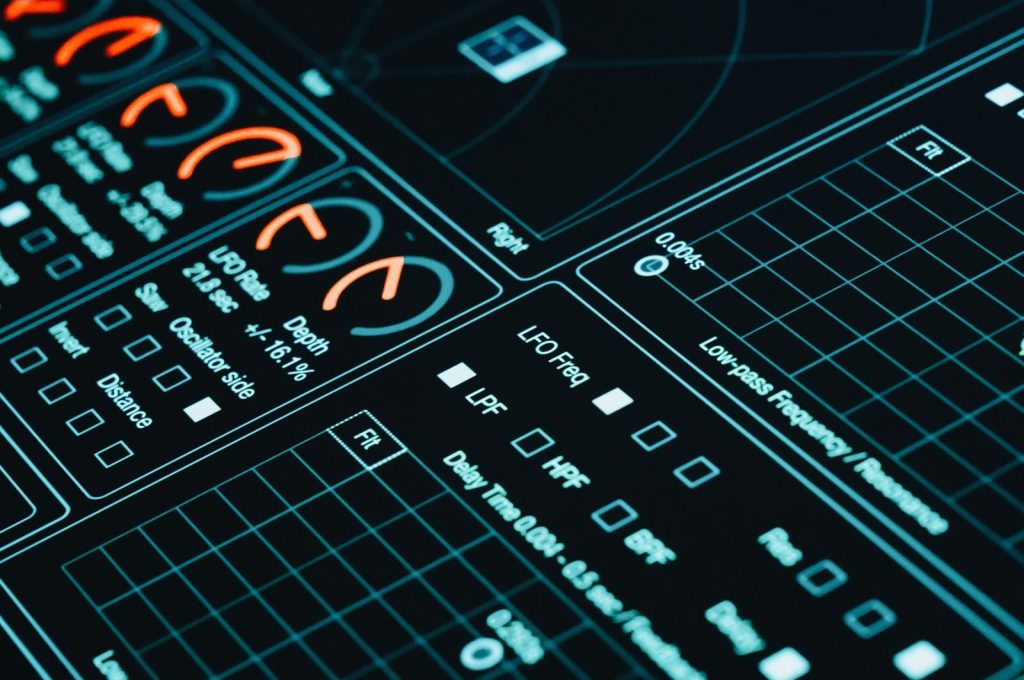 Close-up of a digital interface showcasing futuristic graphs and data analytics in low light.