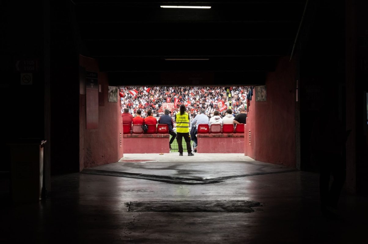 A dynamic stadium perspective through the tunnel showcasing engaged spectators during a game.