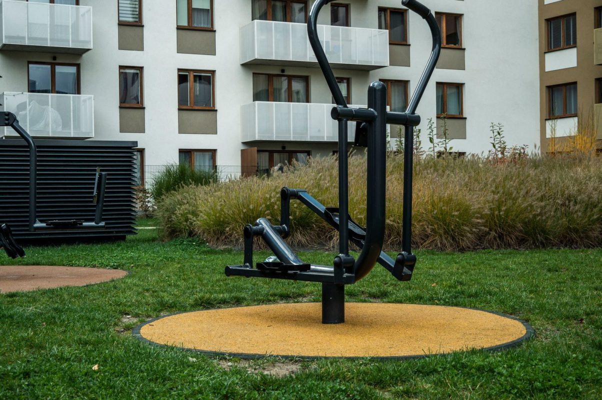 Outdoor gym equipment in a modern urban residential area, perfect for exercise.