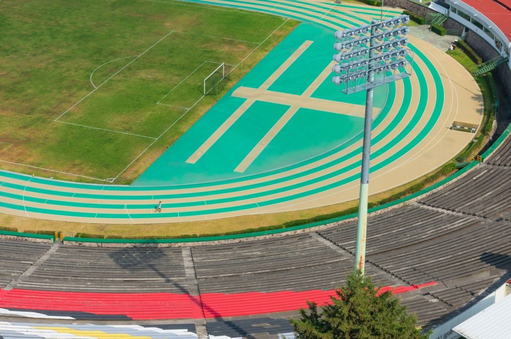 Aerial photograph of an outdoor sports track and stadium in Toluca de Lerdo, Mexico, capturing vibrant colors and athletic design.