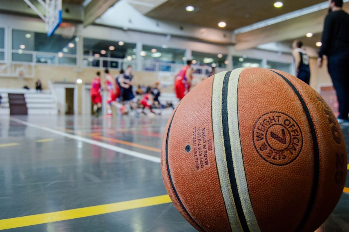 Captivating indoor basketball scene with players actively engaged in a game.